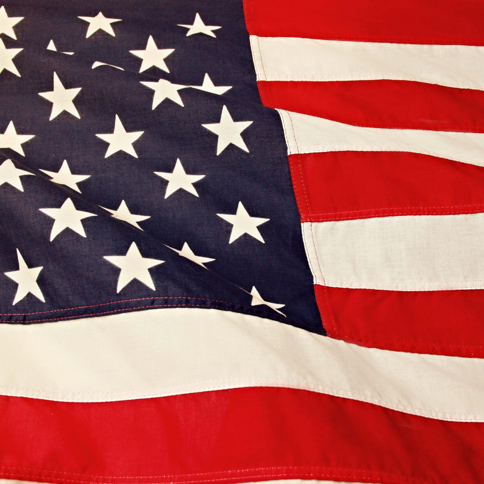 Detailed image of the American flag showcasing the stars and stripes symbolizing USA's patriotism and pride.